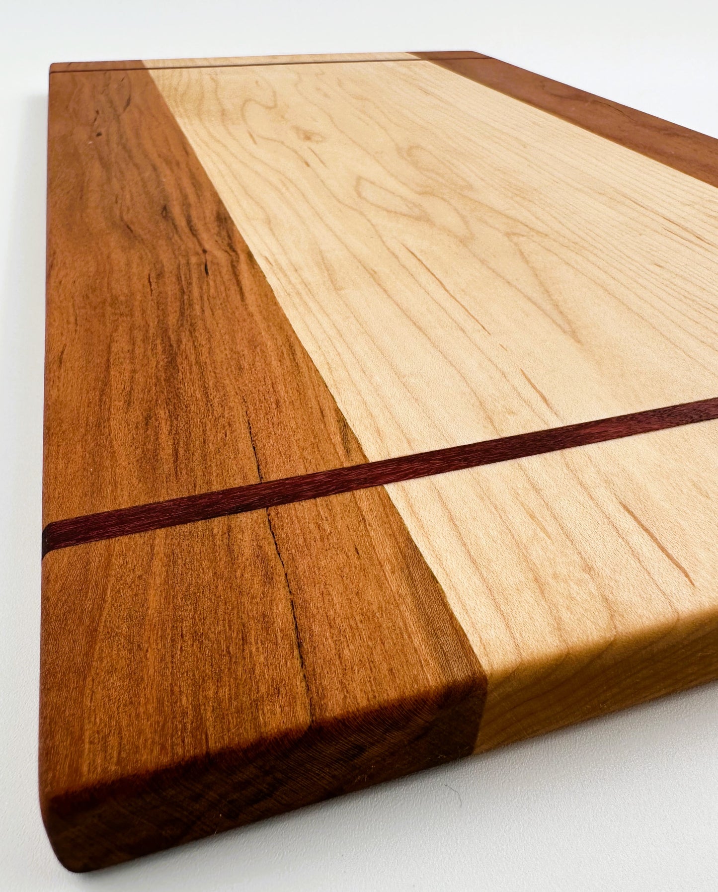 Maple Cutting Board with Cherry Edging and Purple Heart Inlay